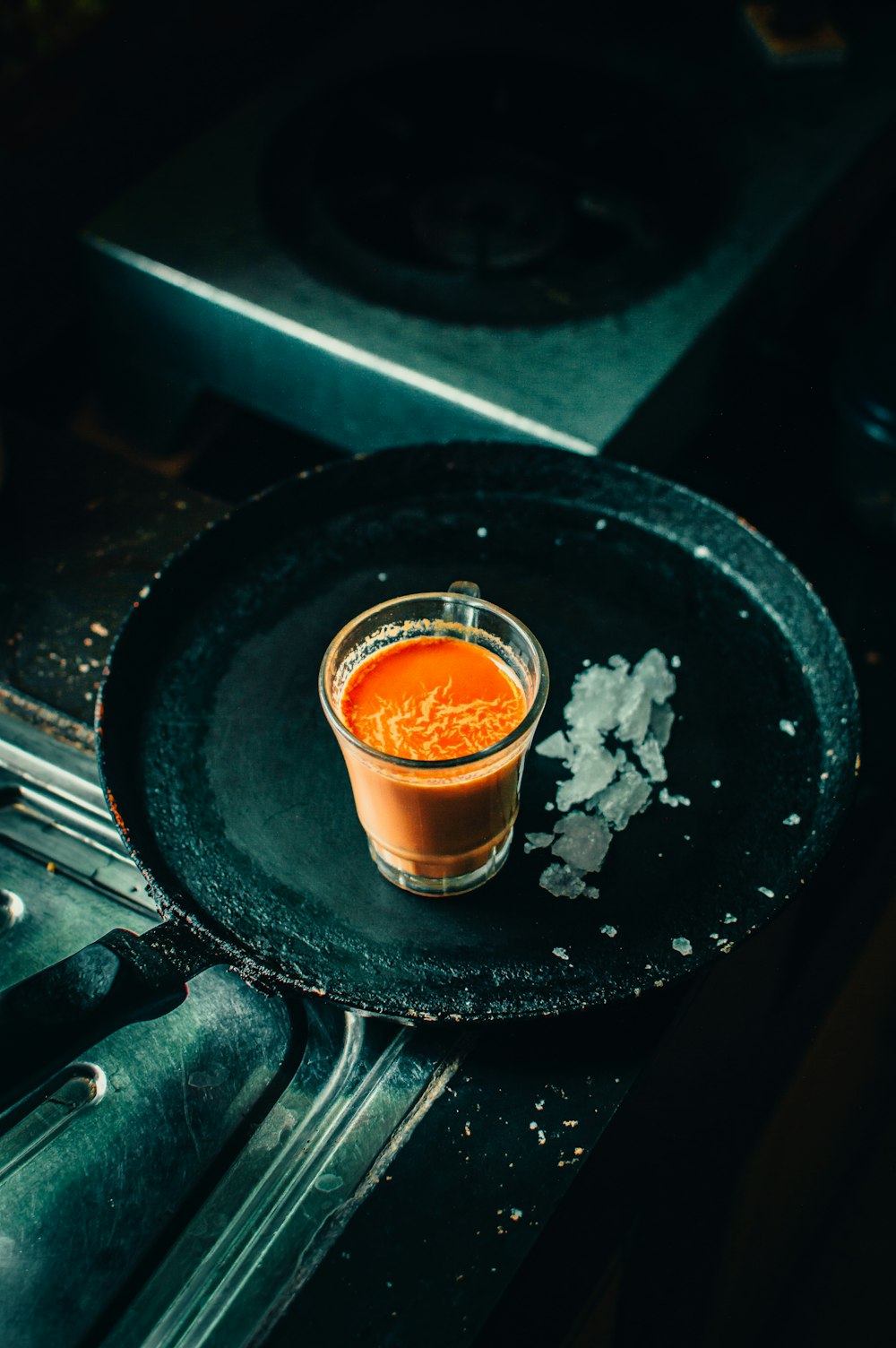 clear glass cup with brown liquid inside