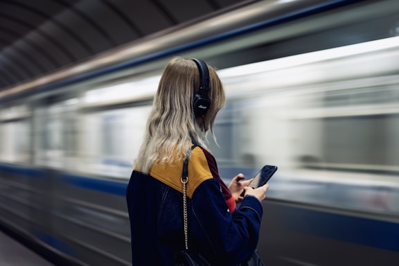 woman in black jacket holding smartphone