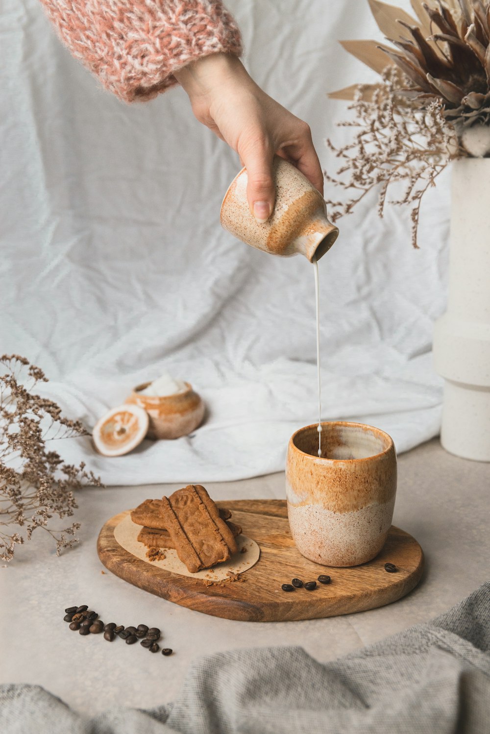 person pouring coffee on white ceramic mug