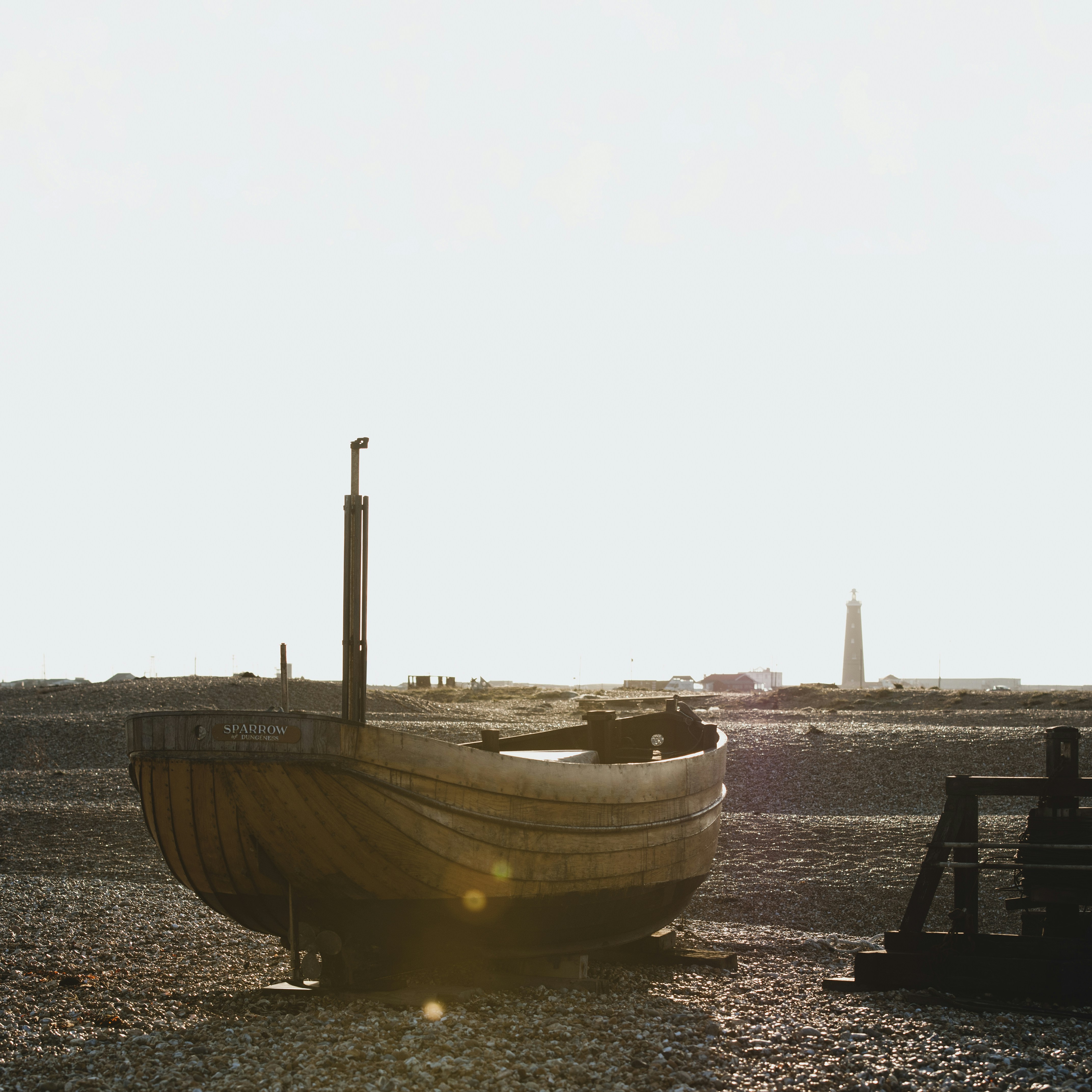 brown and white boat on sea shore during daytime