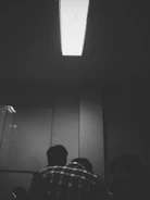 A focused individual mentoring a small group in a quiet, well-lit room.