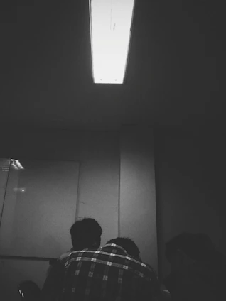 A focused group of traders analyzing charts together in a modern, dark-themed trading room.