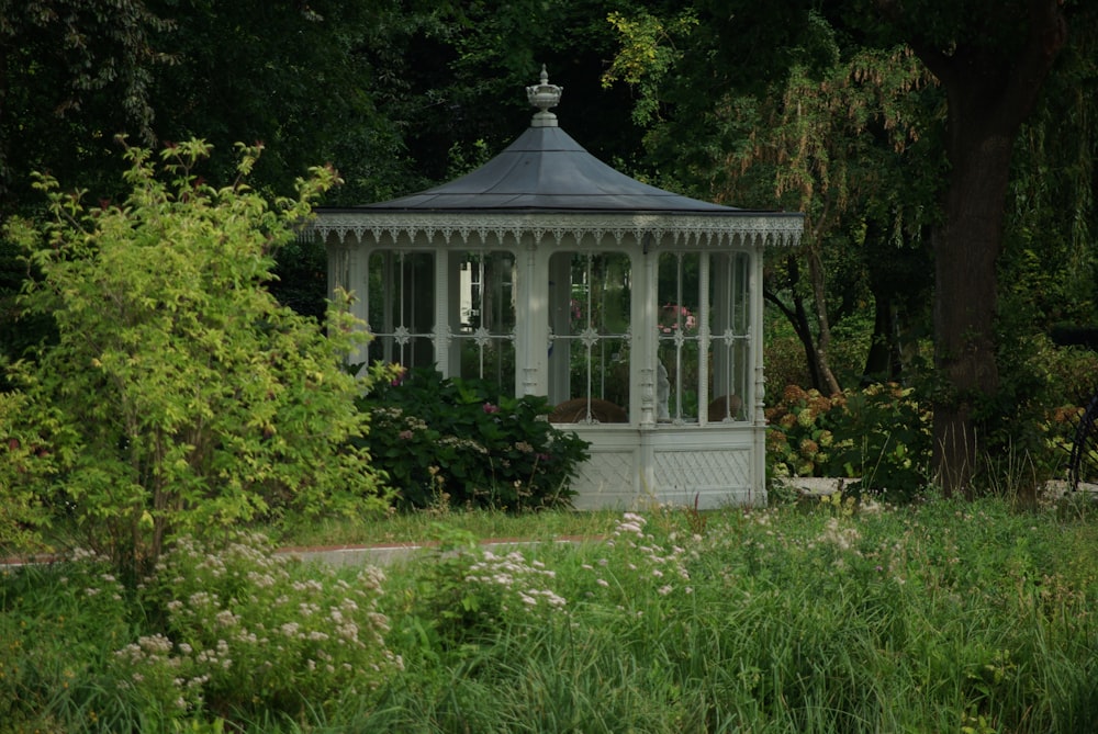 white and gray concrete house surrounded by green trees during daytime