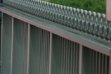 Close-up of a sturdy metal fence with decorative elements, highlighting craftsmanship.