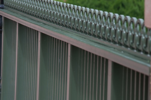A detailed view of a metal fence installation.