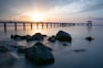 gray concrete bridge over body of water during daytime