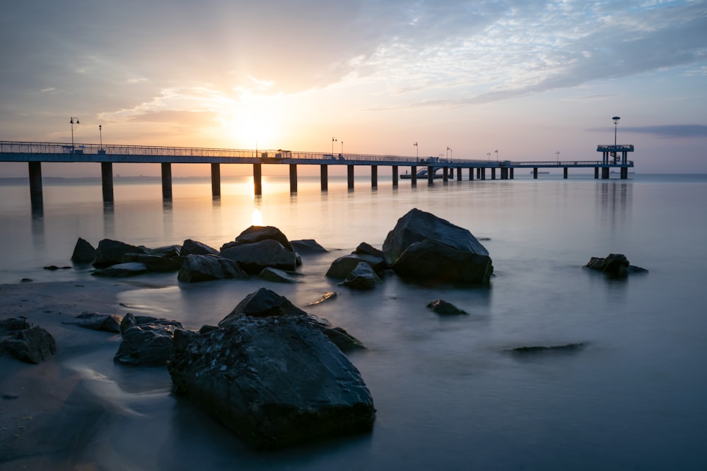 gray concrete bridge over body of water during daytime