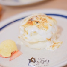 A delicious serving of fluffy soufflé pancakes on a rustic plate.