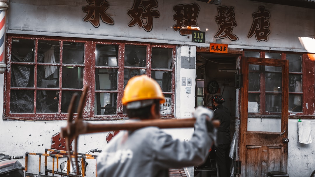 man in white jacket wearing yellow helmet