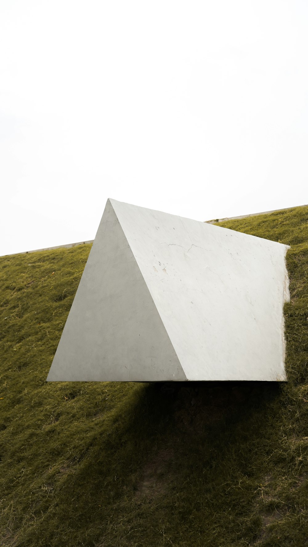 white concrete wall on green grass field during daytime