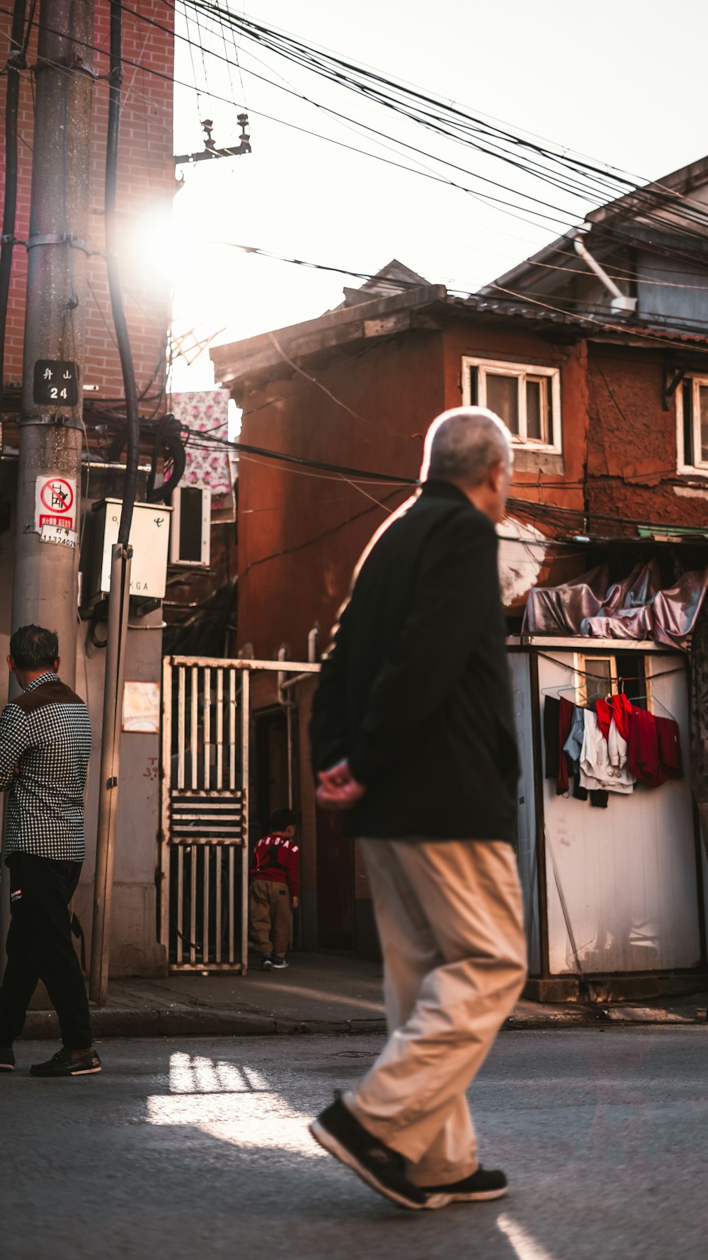 man in black blazer standing near woman in black and white stripe shirt