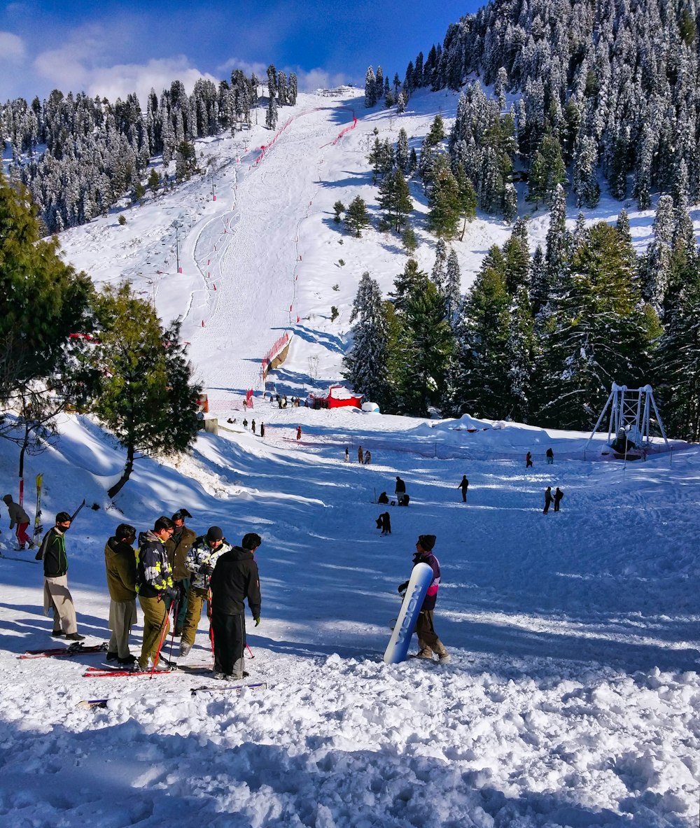 people walking on snow covered ground during daytime