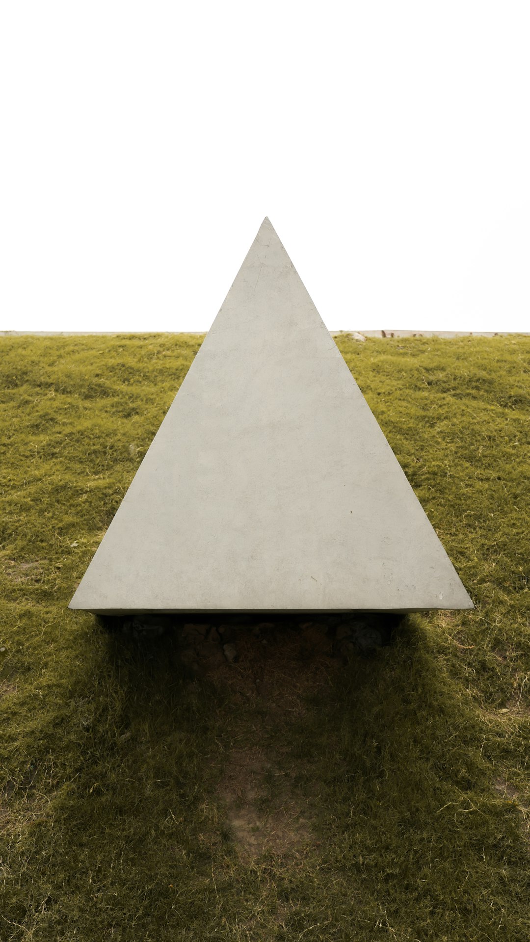 gray concrete pyramid on green grass field