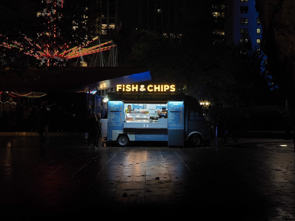 white and blue truck on road during night time