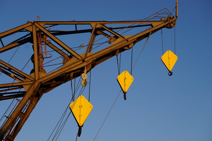 yellow and black crane under blue sky during daytime