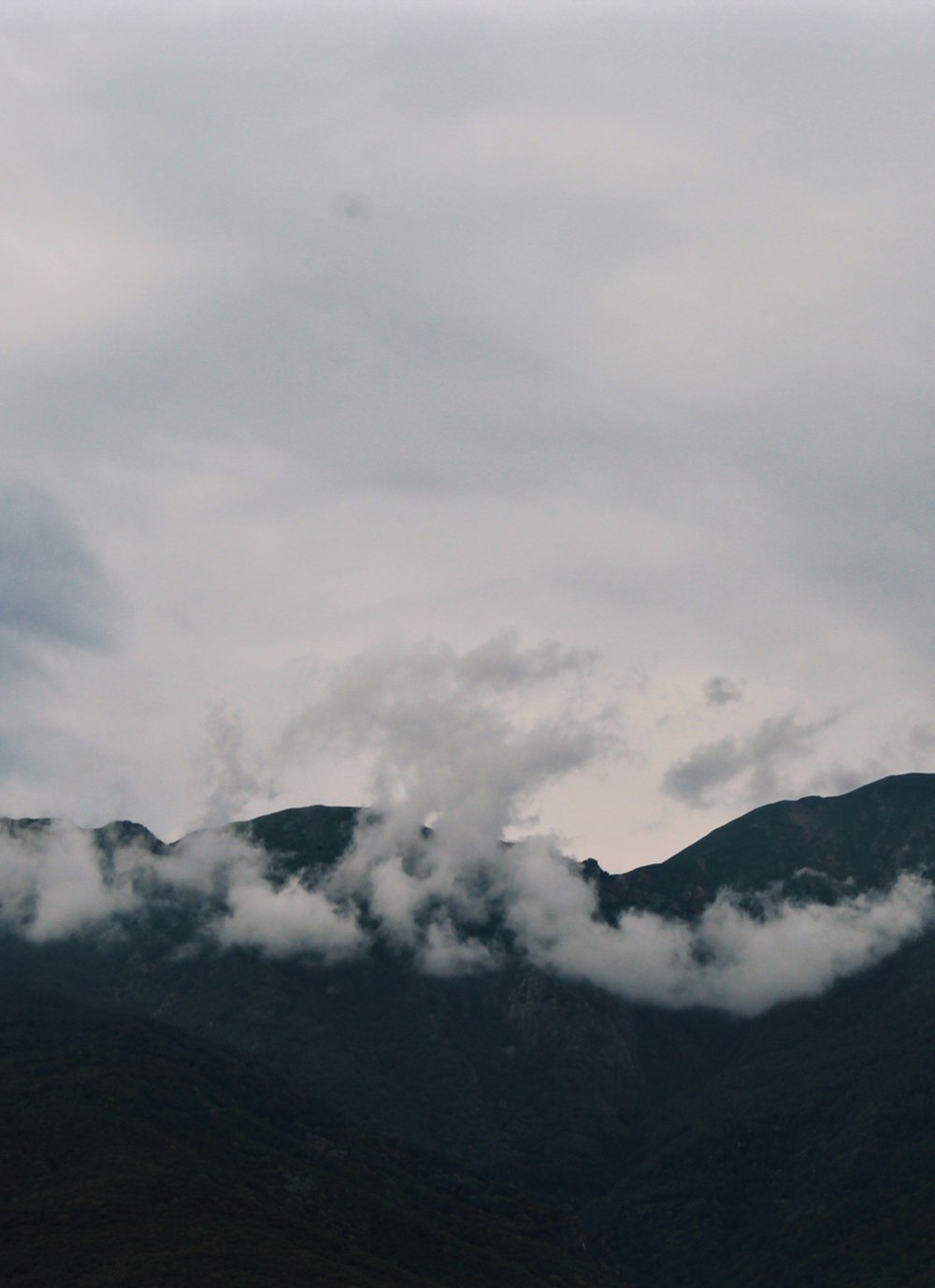 black mountain under white clouds
