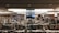 A large bookstore with numerous bookshelves organized by categories such as humanities, religion, new age, and law. The shelves are densely packed with a wide variety of books. Overhead lights illuminate the space, creating a cozy and inviting atmosphere.