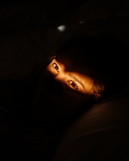 woman lying on black textile