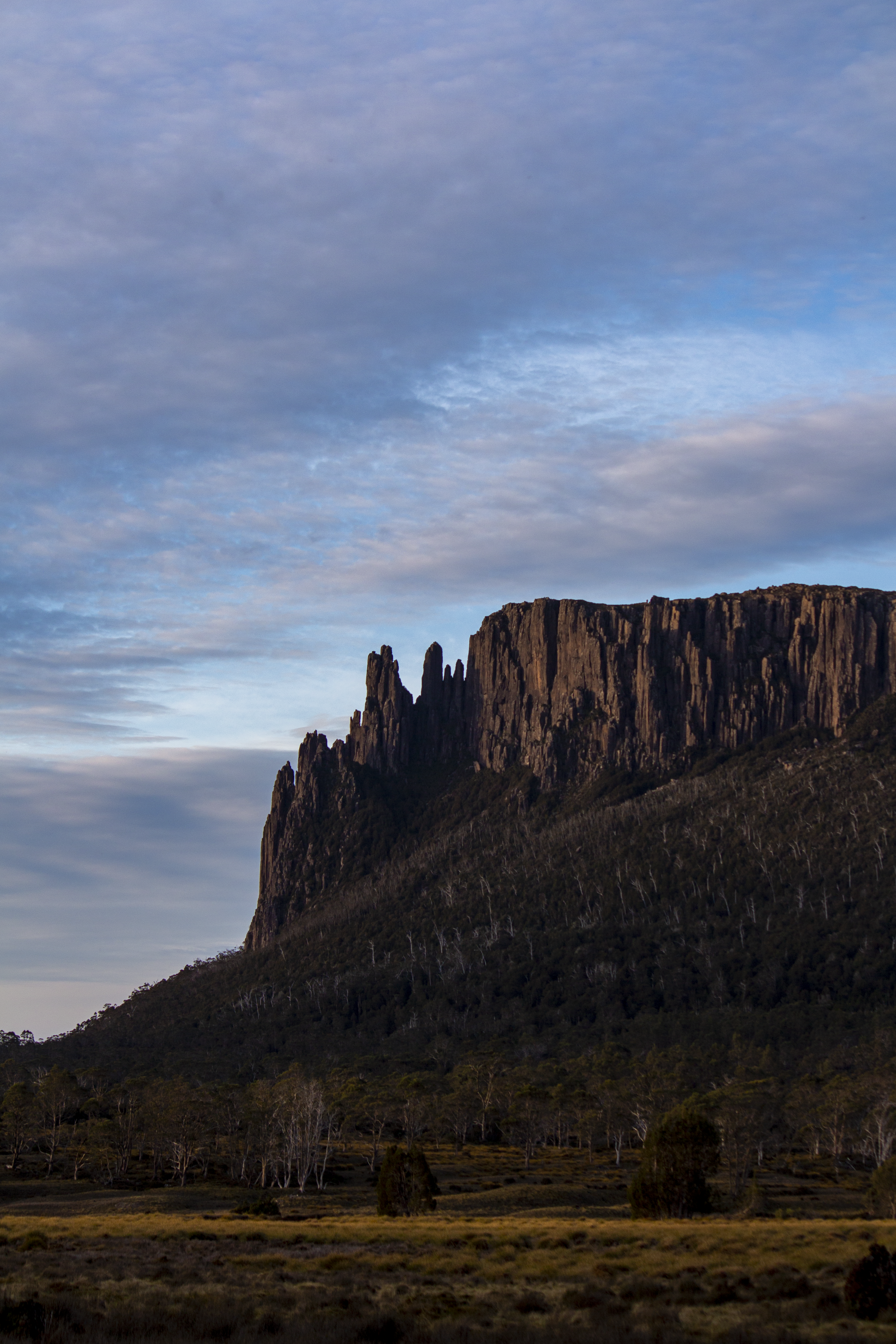 brown rocky mountain under cloudy sky during daytime