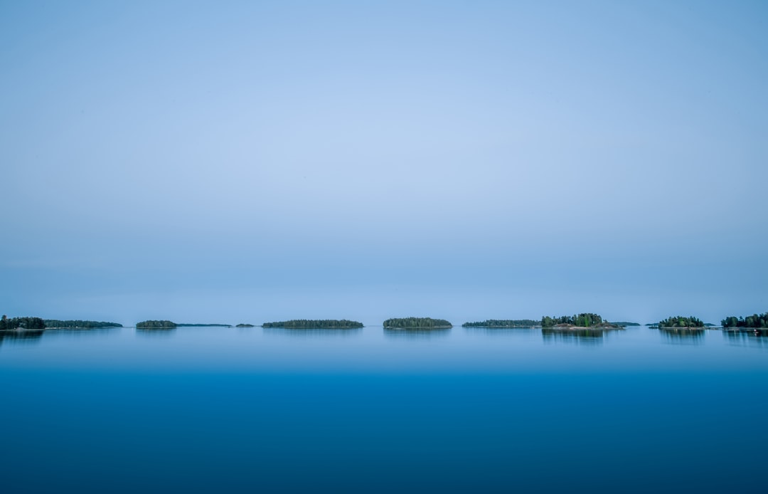 body of water near mountain during daytime