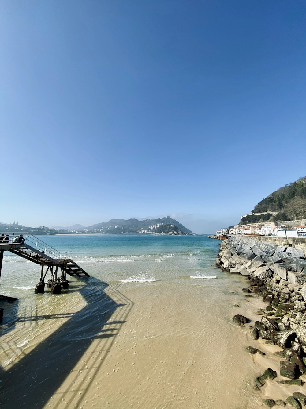 brown wooden dock on beach during daytime