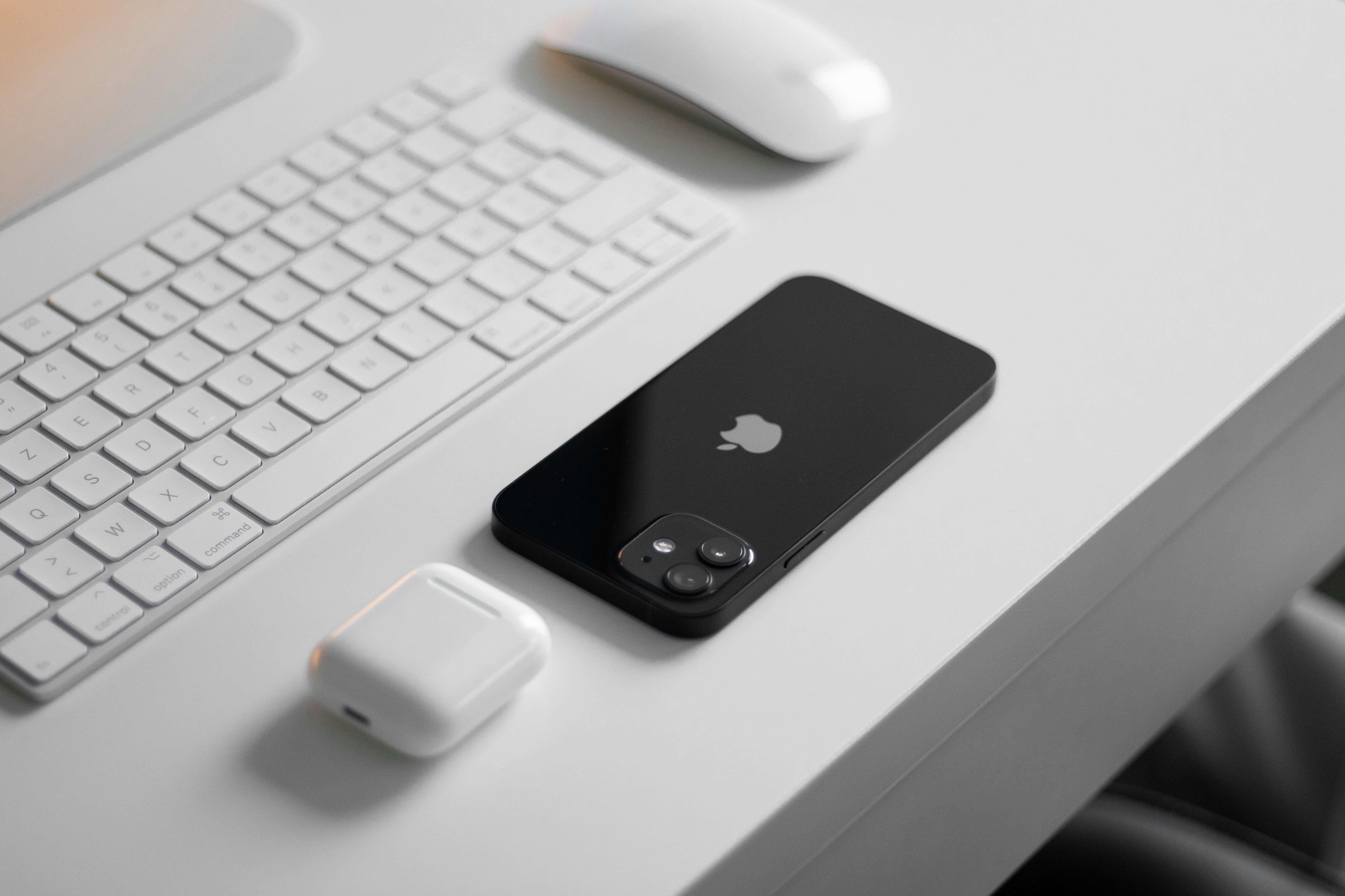 black iphone 4 on white computer keyboard