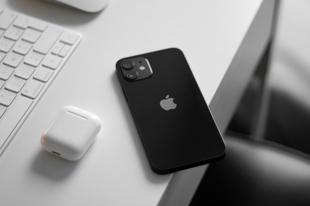 apple airpods charging case on white table