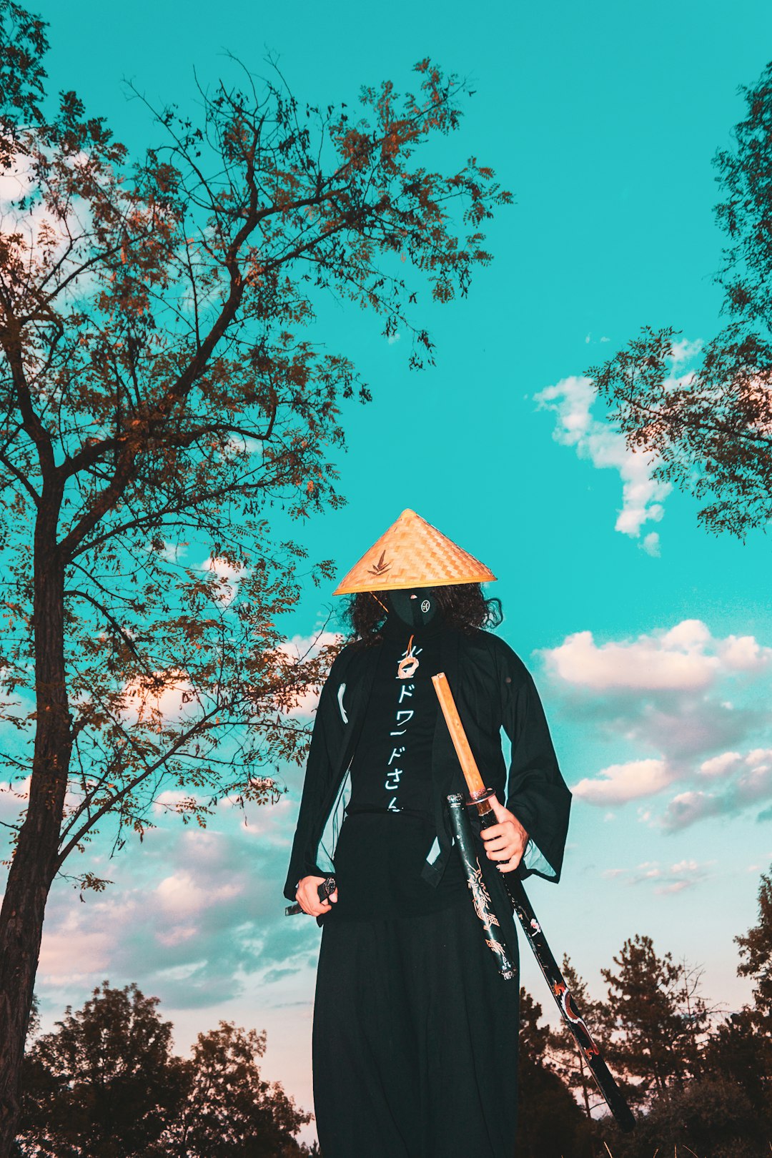 person in black coat standing under brown tree during daytime