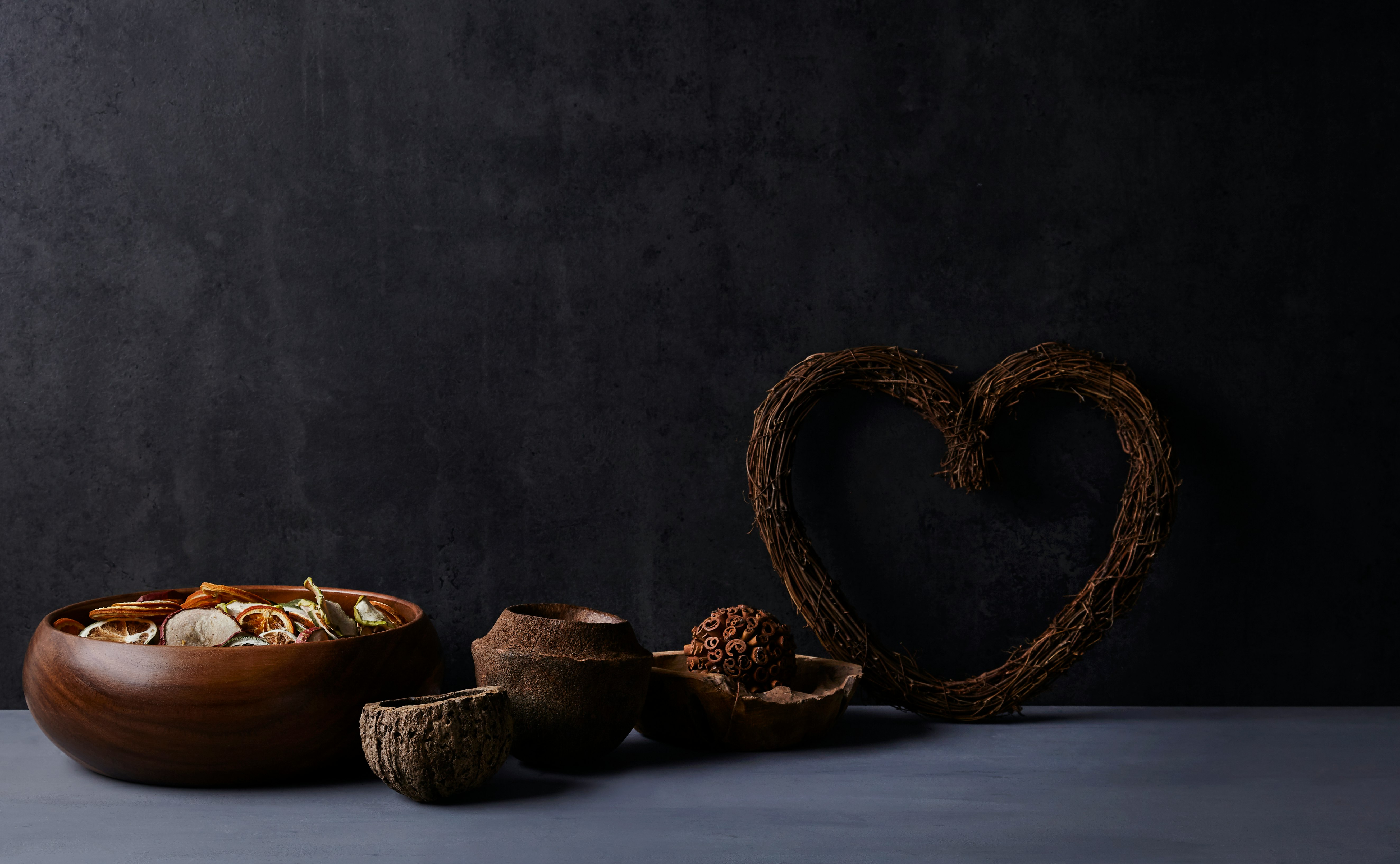 brown woven basket with brown and black ceramic bowls