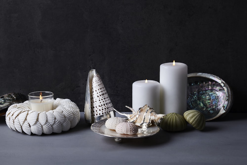 white pillar candles on white table