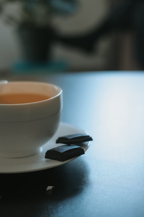 white ceramic cup with brown liquid