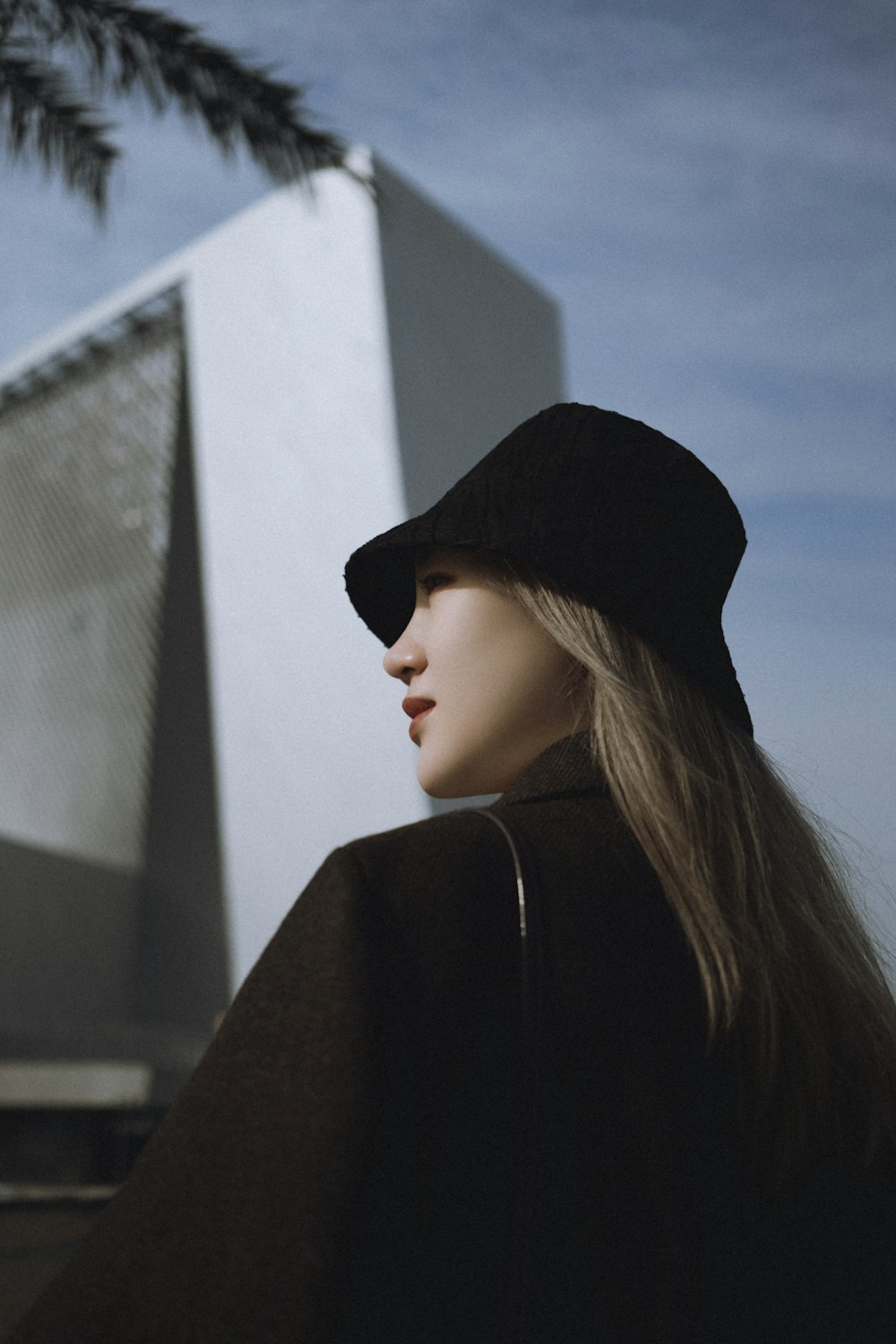 woman in black hat and black coat