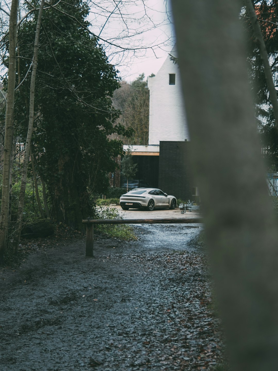 white sedan parked near white concrete building during daytime