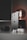 A sleek smartphone with a metallic finish stands upright on a table alongside a modern smartwatch, wireless earbuds, and a glowing antique-style bulb. The scene is set against a dark background, emphasizing the shiny surfaces and elegant technology.