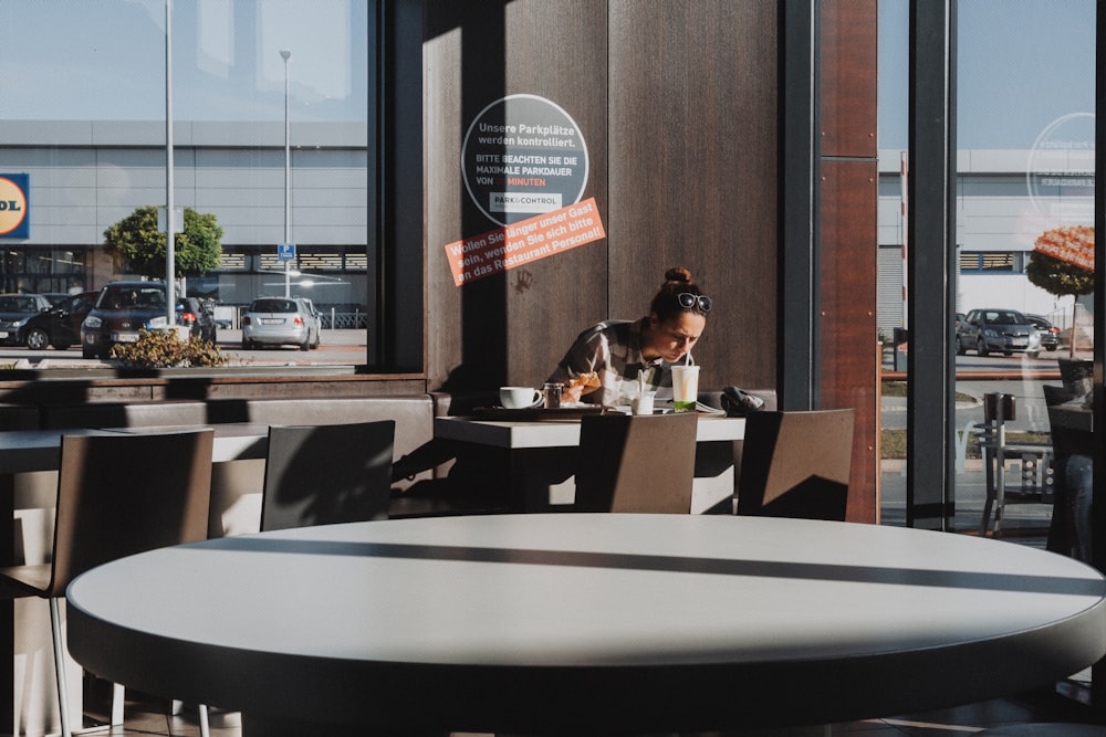 man and woman sitting on chair in restaurant