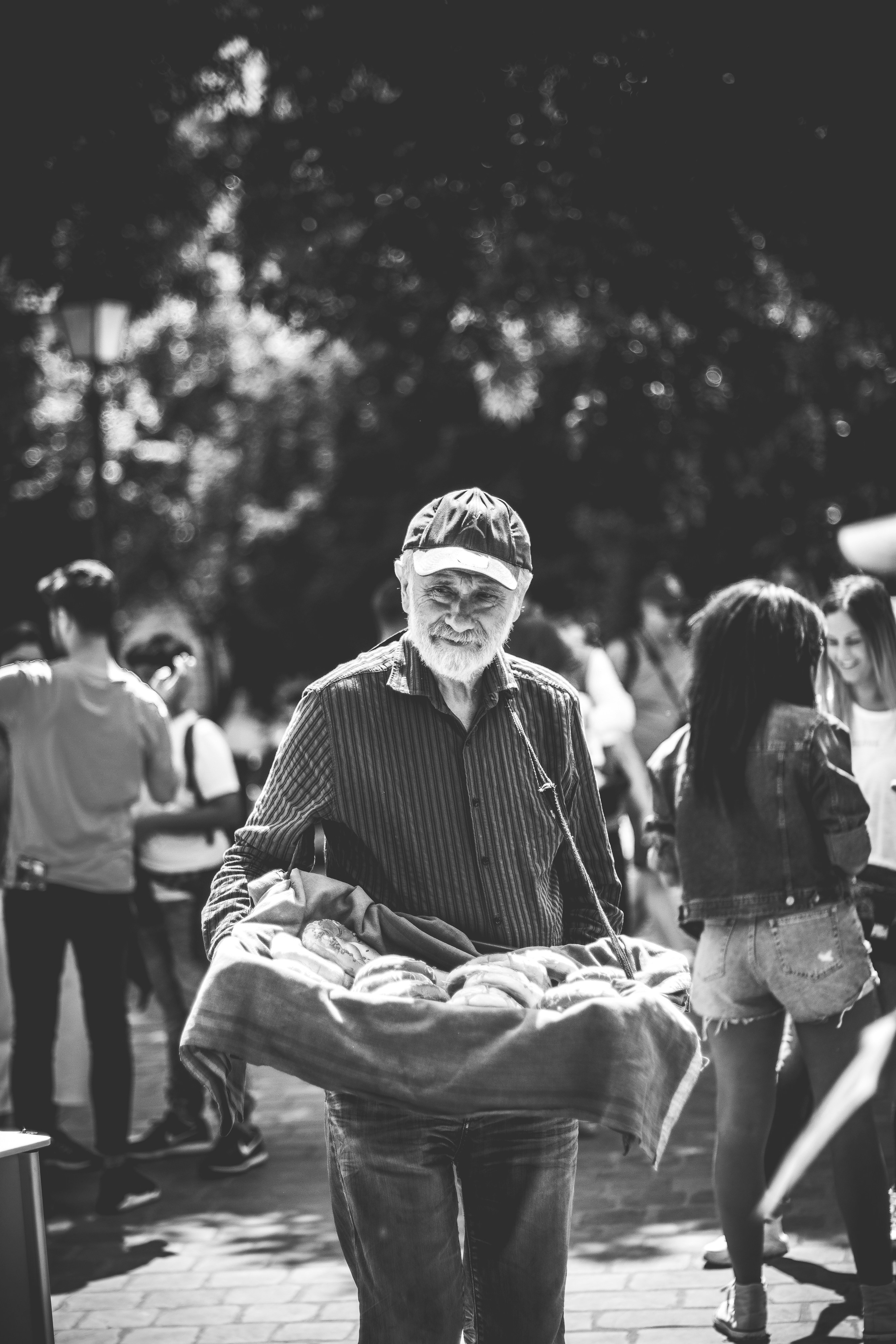 Man in black and white striped dress shirt and black pants sitting on