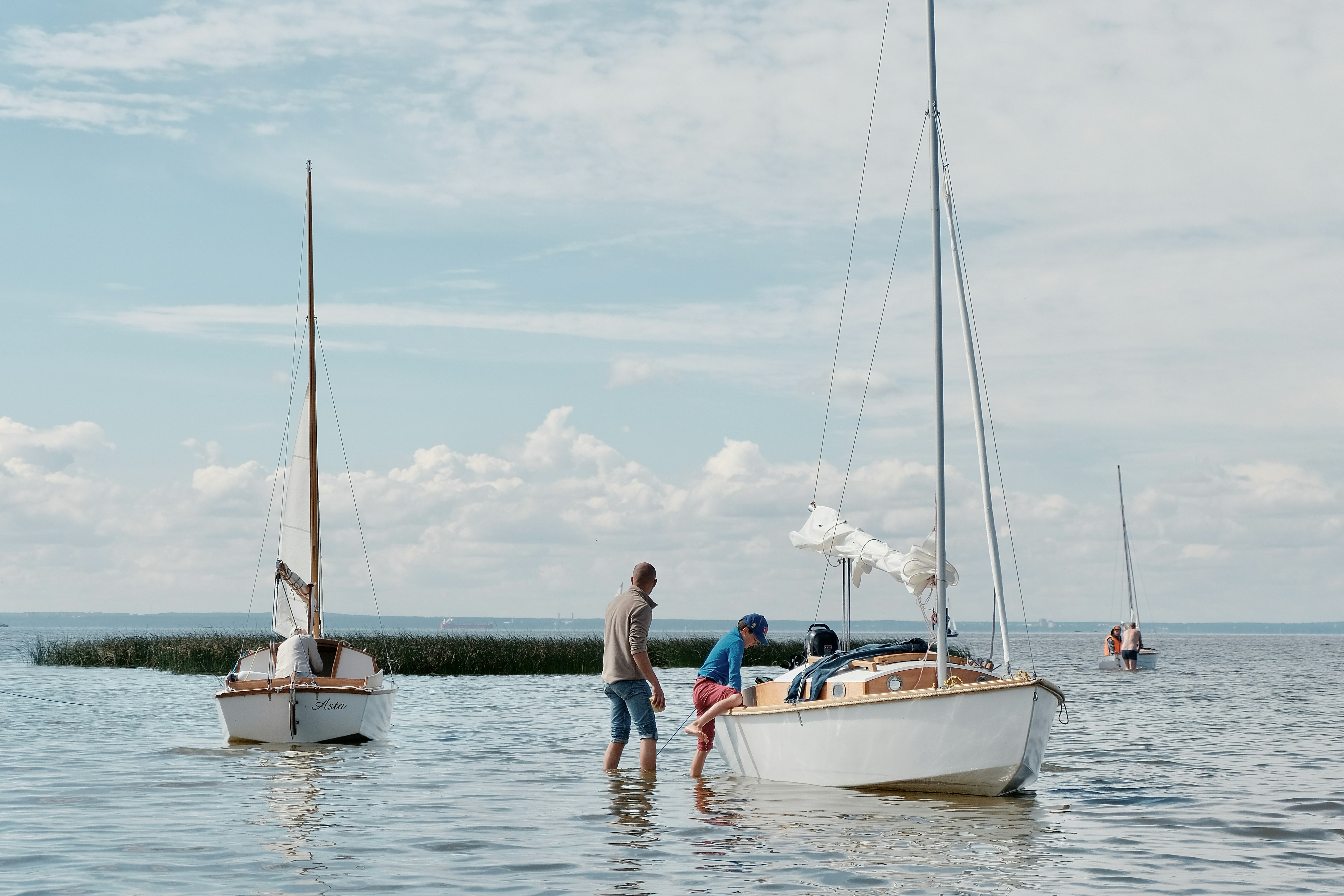 2 women sitting on white boat during daytime