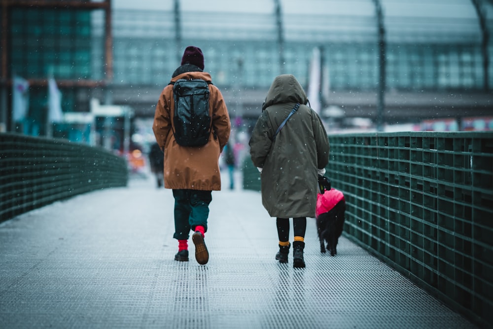 2 person walking on sidewalk during daytime