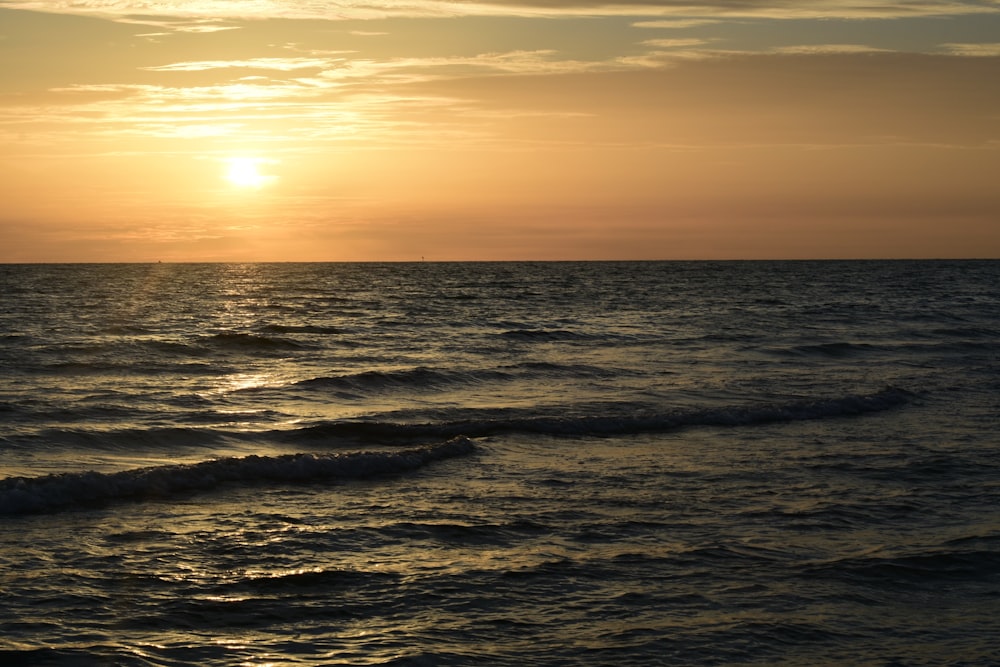 body of water during sunset