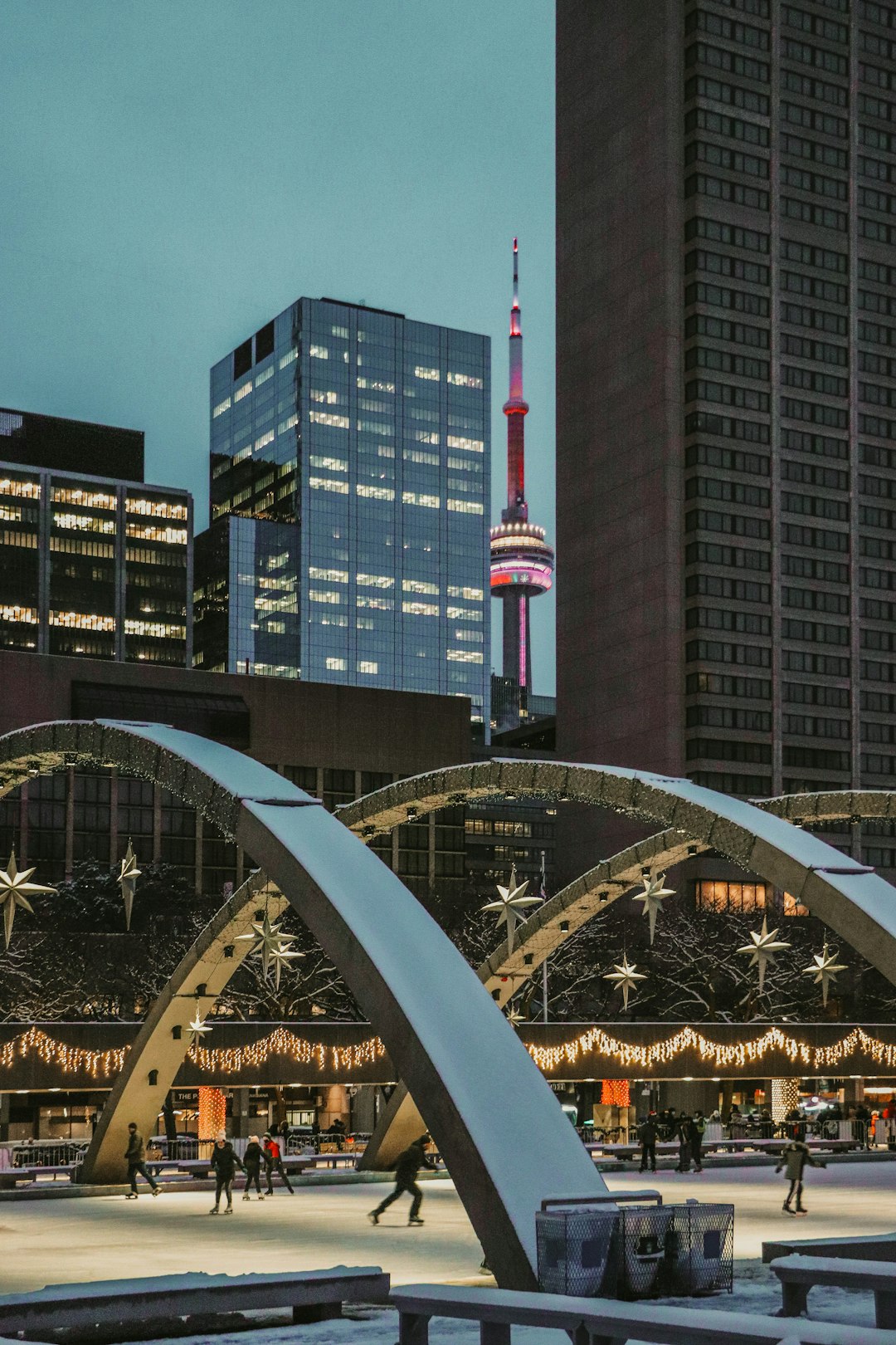 white and red bridge across city buildings during daytime