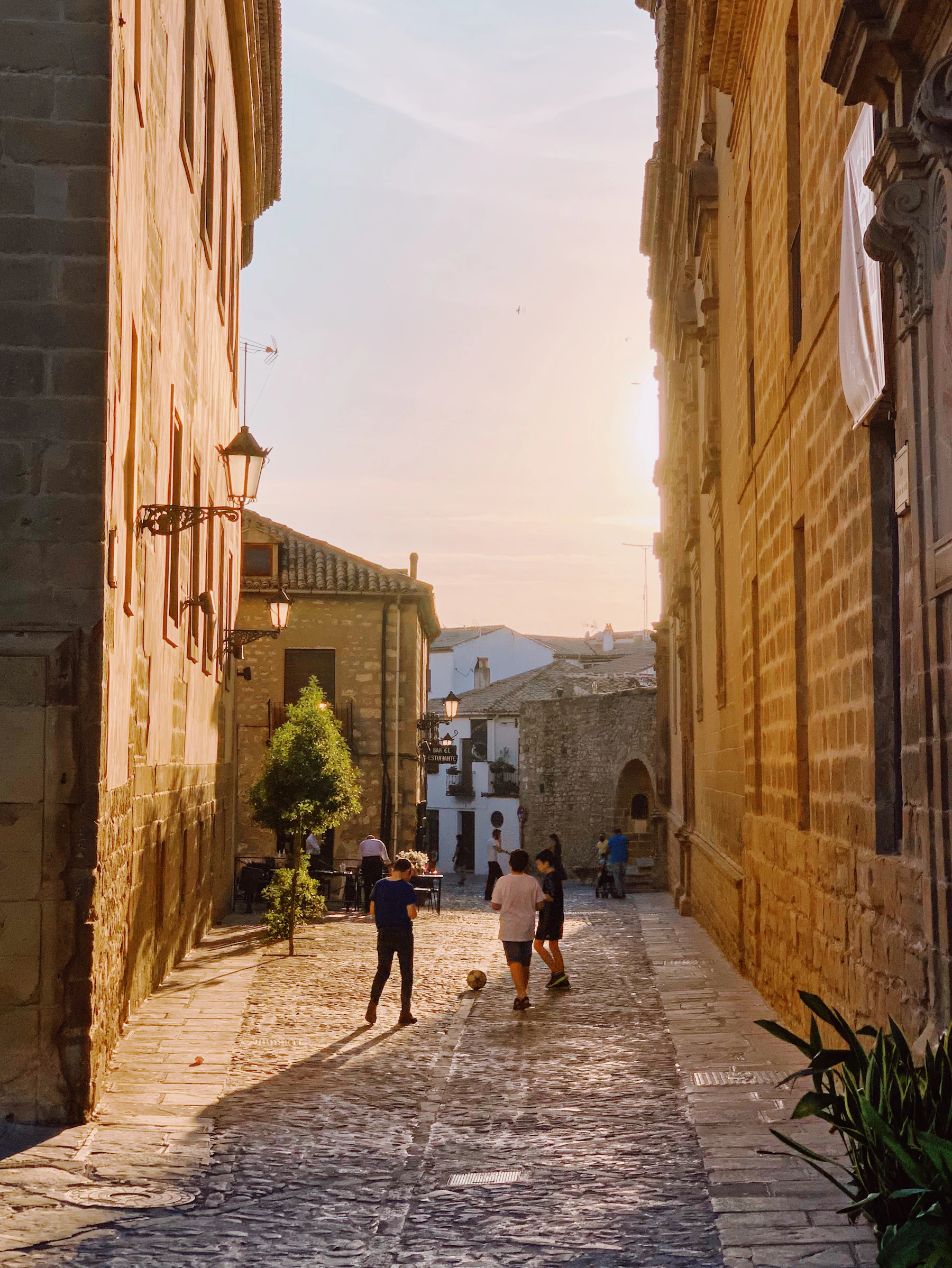 Children playing on a warm stone village street