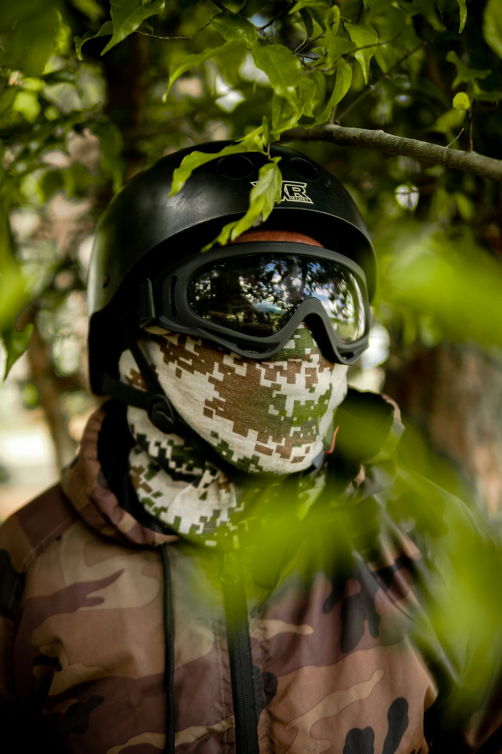 man in green and brown camouflage jacket wearing black helmet