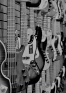 A close-up of various guitars hanging on a wall.