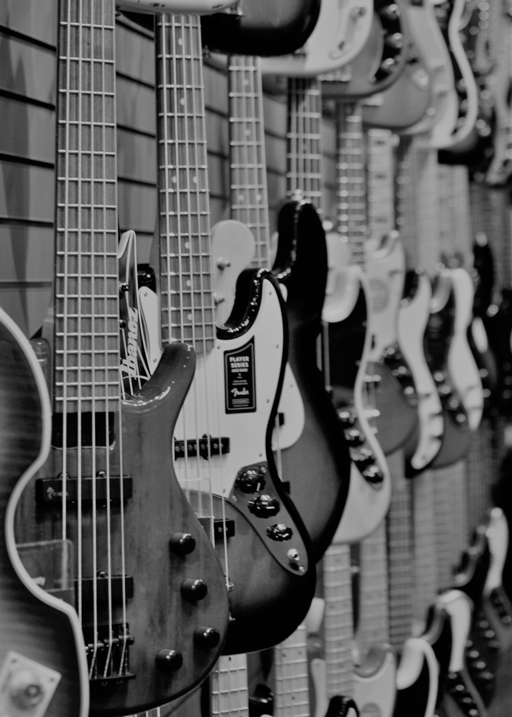 grayscale photo of electric guitars