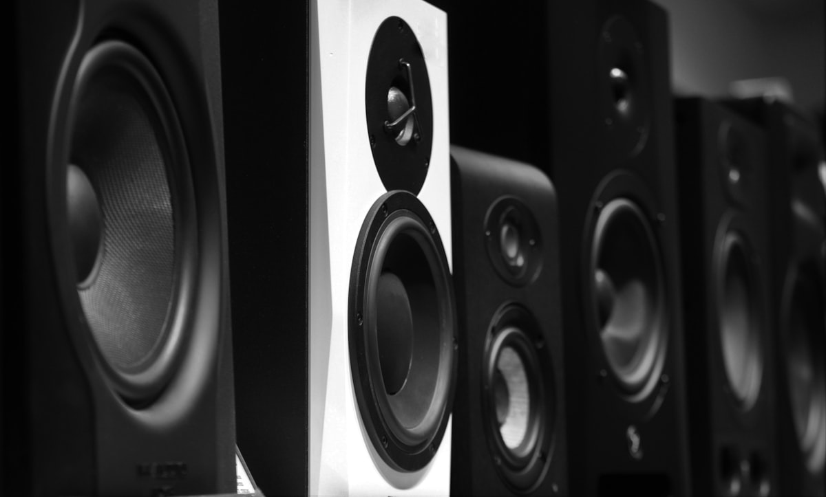 Pair of bookshelf speakers on a wooden table in a home listening room
