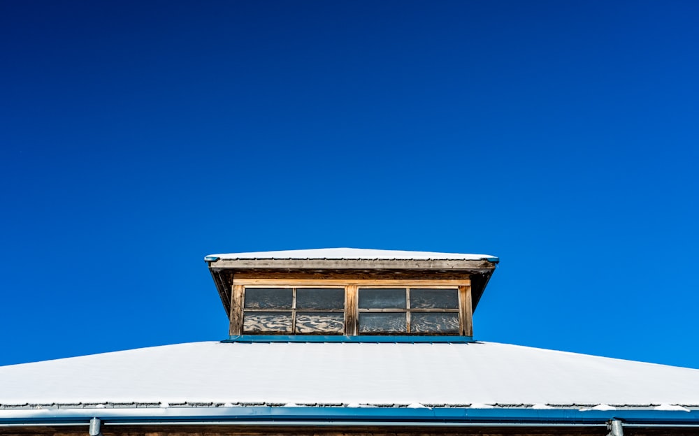 white and brown wooden house under blue sky during daytime