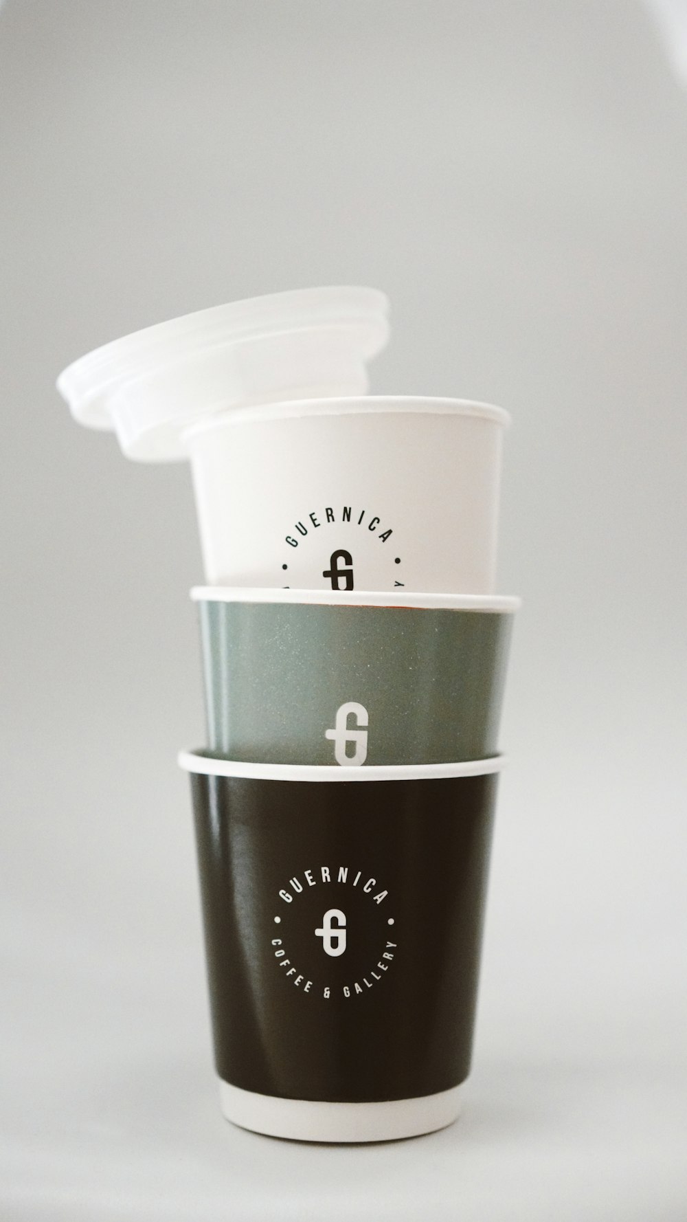 white and black disposable cup