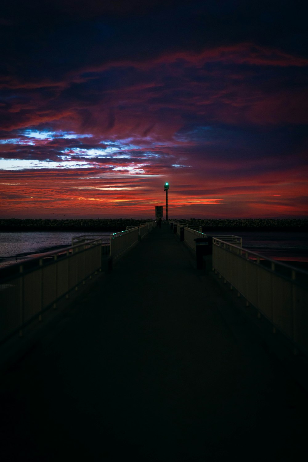 brown wooden dock on sea during sunset