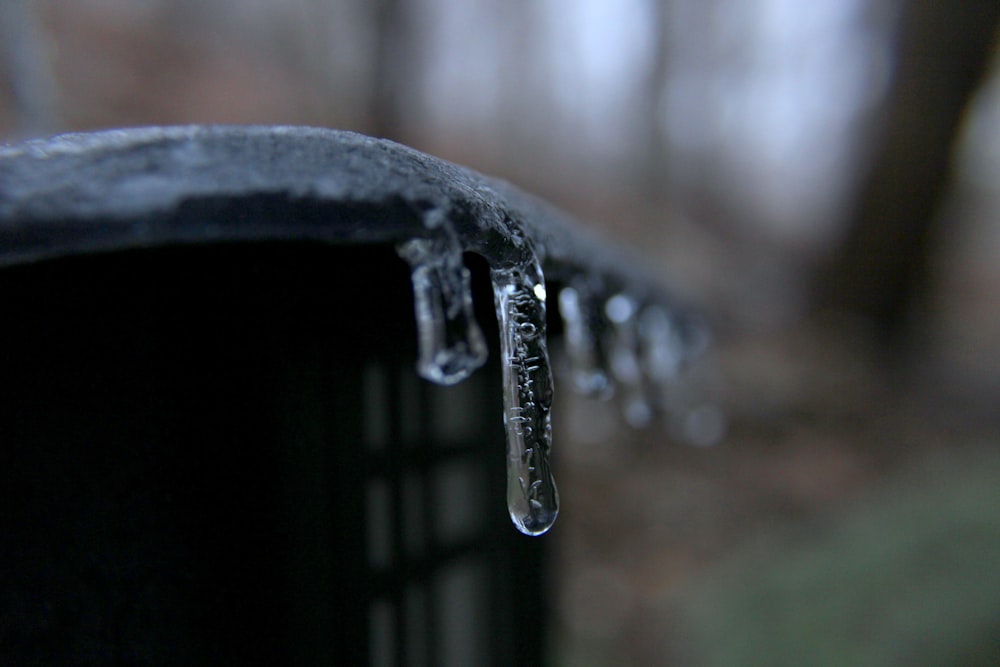 water droplets on black metal bar