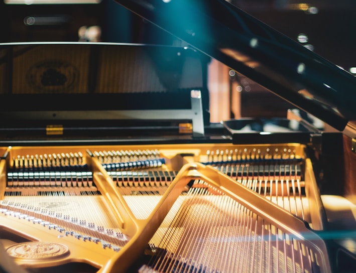 brown and black piano in room